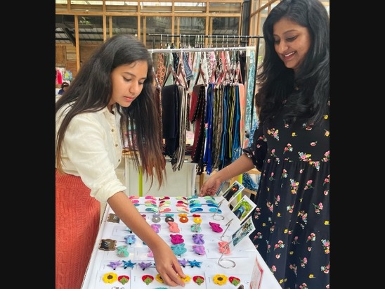 Hands crocheting with terracotta yarn